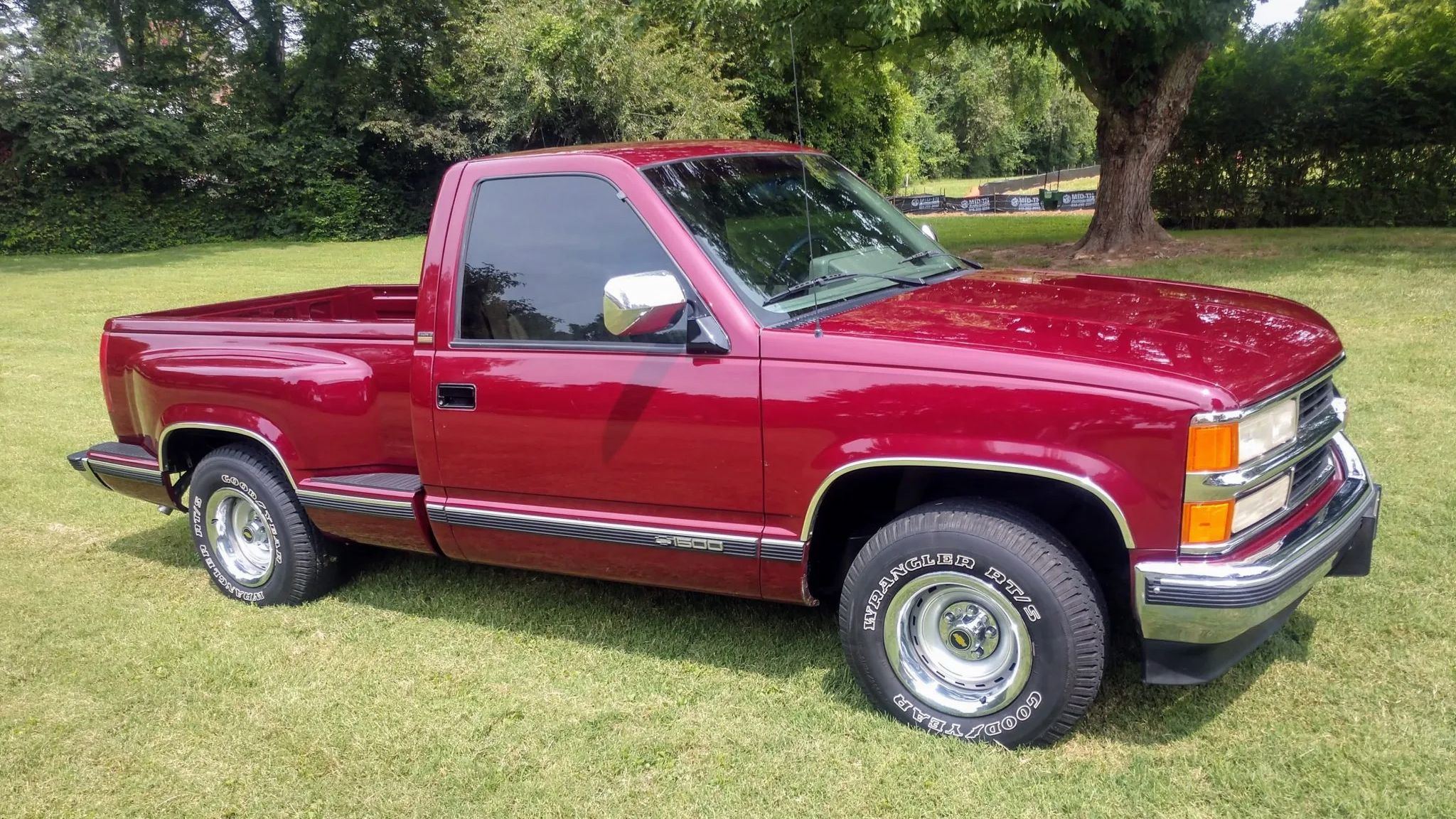 A parked Red '94 Chevrolet K1500 on grass