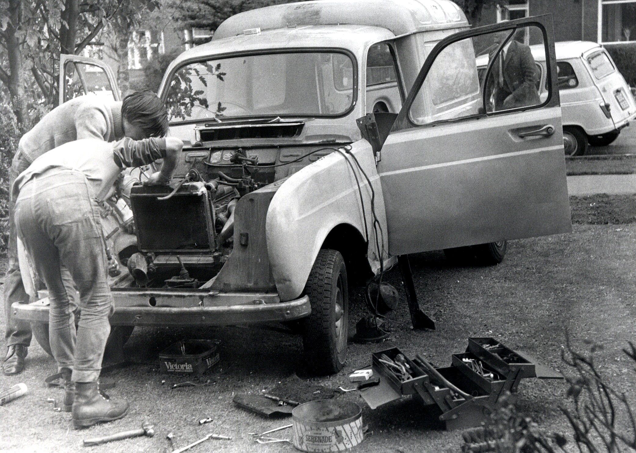 Black and white image of mechanics working on Renault